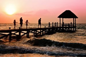 A family walking over pier.