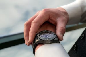 person looking at watch while waiting for Broward County movers