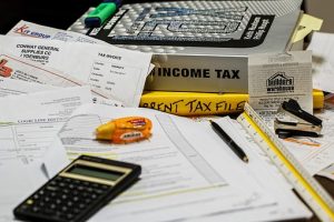 papers, calculator and pencil on the office desk